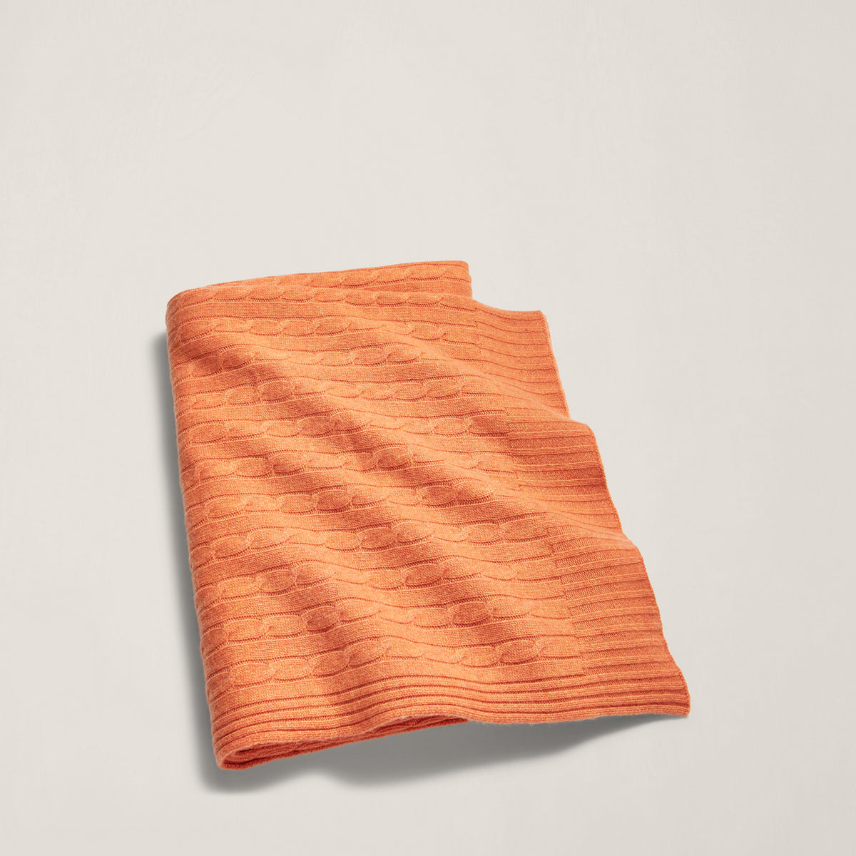 The Iconic Cable Cashmere Throw Blanket in True Tangerine